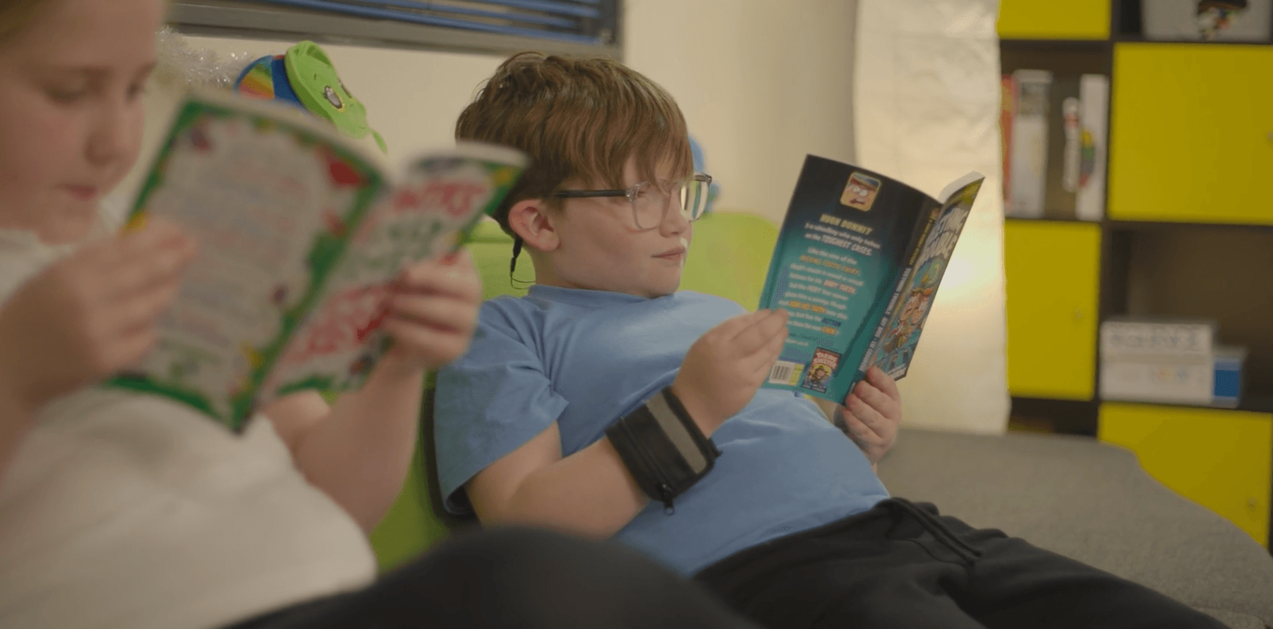 Two young children reading books